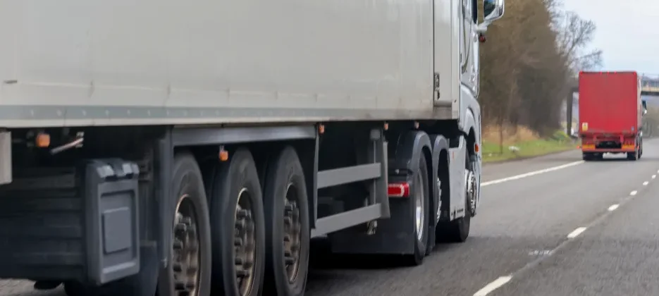 How can I share the road safely with large trucks?